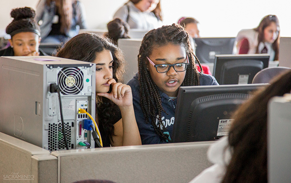 Two girls looking at a computer screen