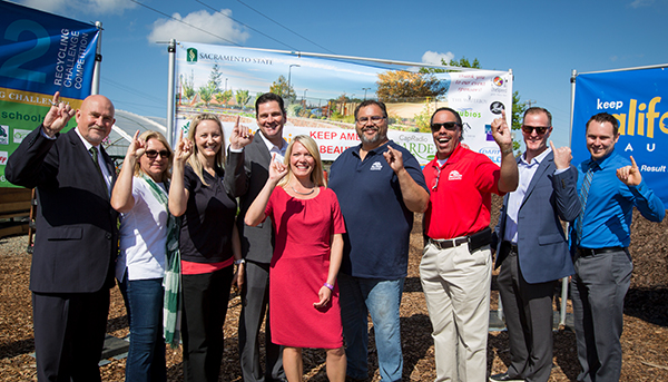 A photo of President Nelsen and Sac State sustainability staff at the compost yard.