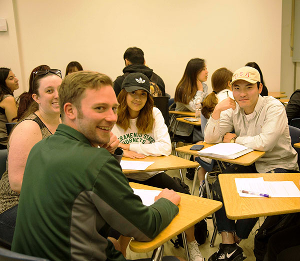 A photo of Sac State and ELI students sitting in a circle during Conversation Club