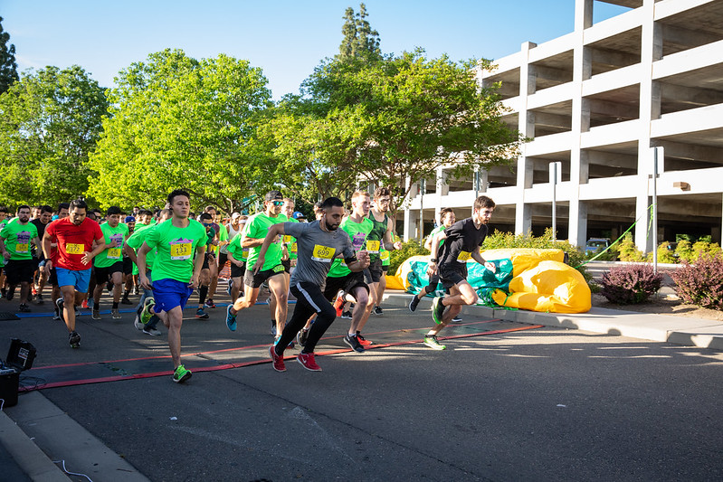 group of people starting to run near a parking garage for Fun Run