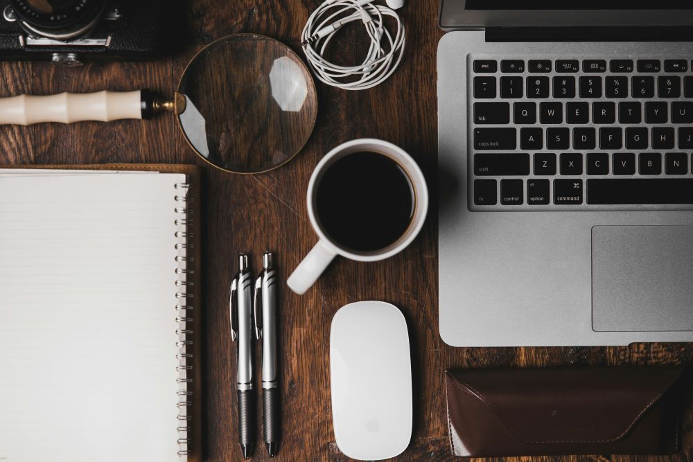 Close up of a office work station with laptop and office supplies