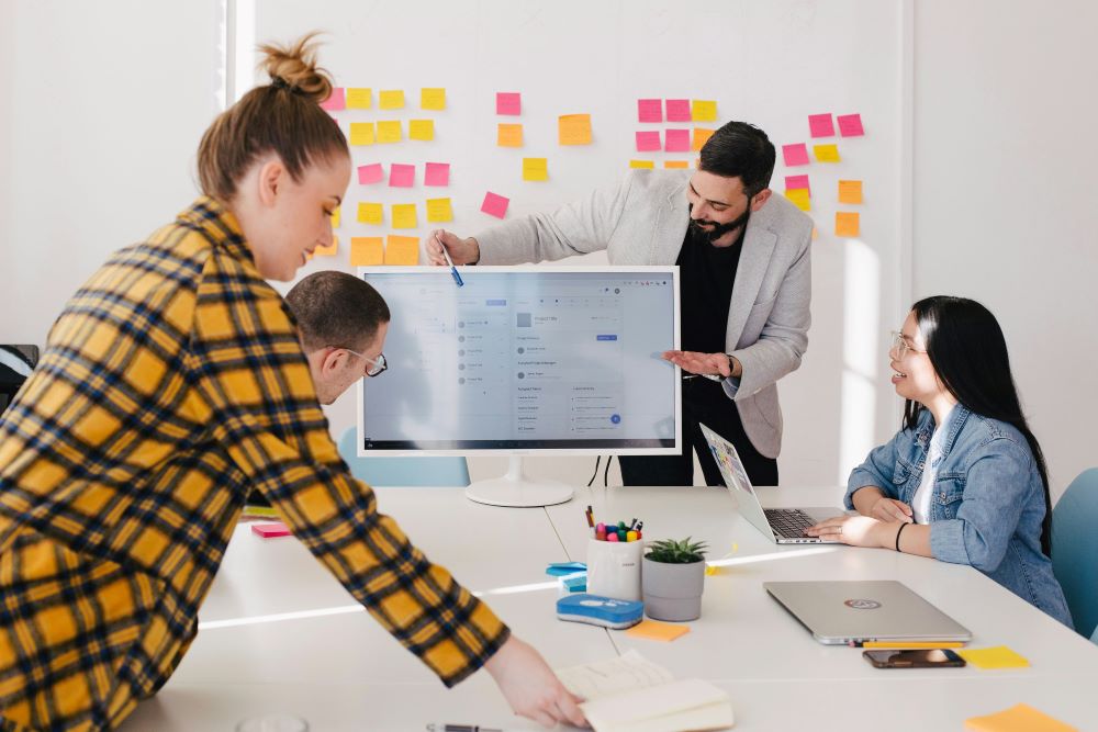 Group of four collaborating in team meeting