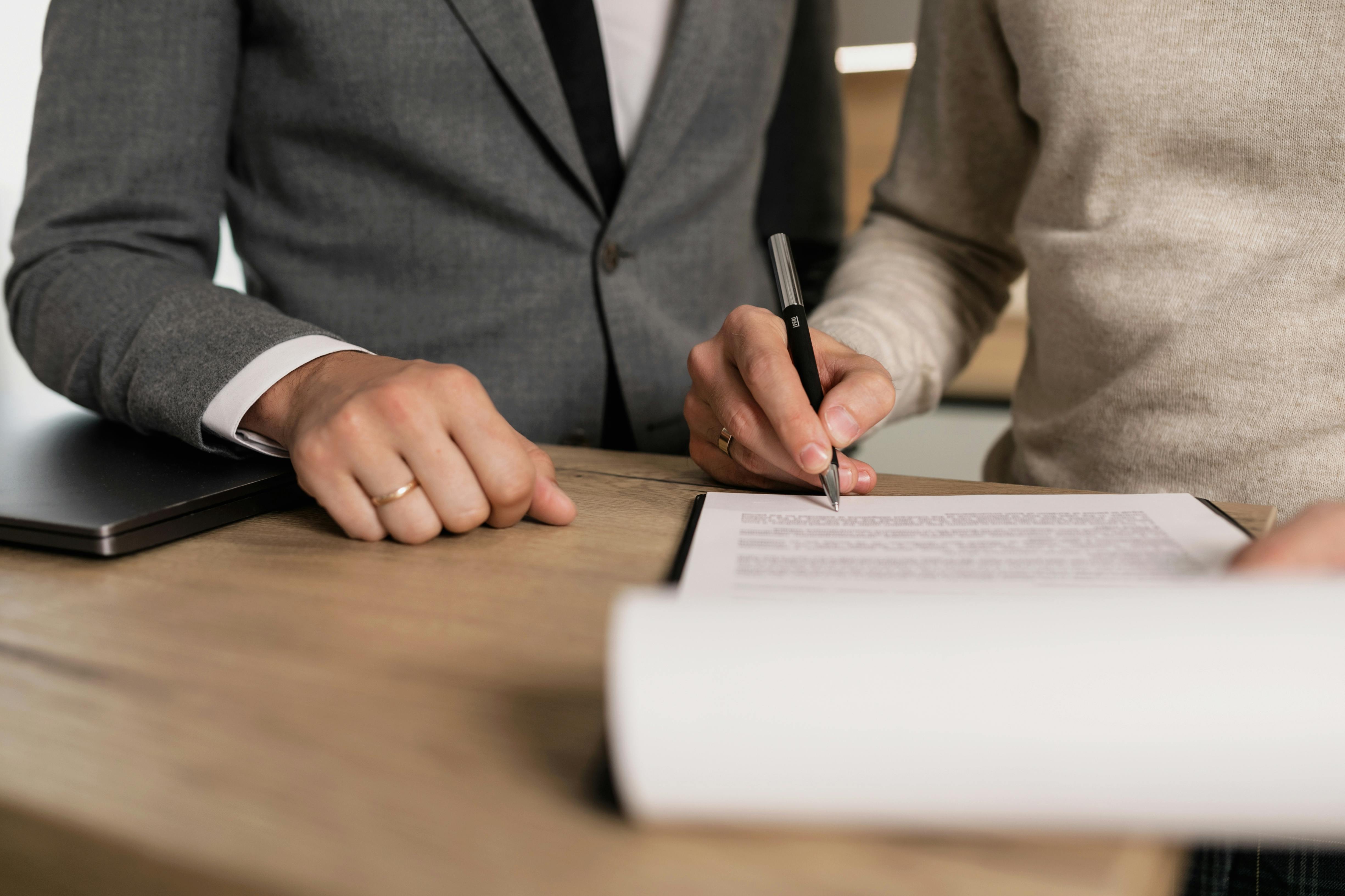 two employees writing business document