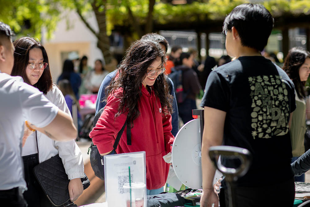 Students at a table doing an activity and smiling