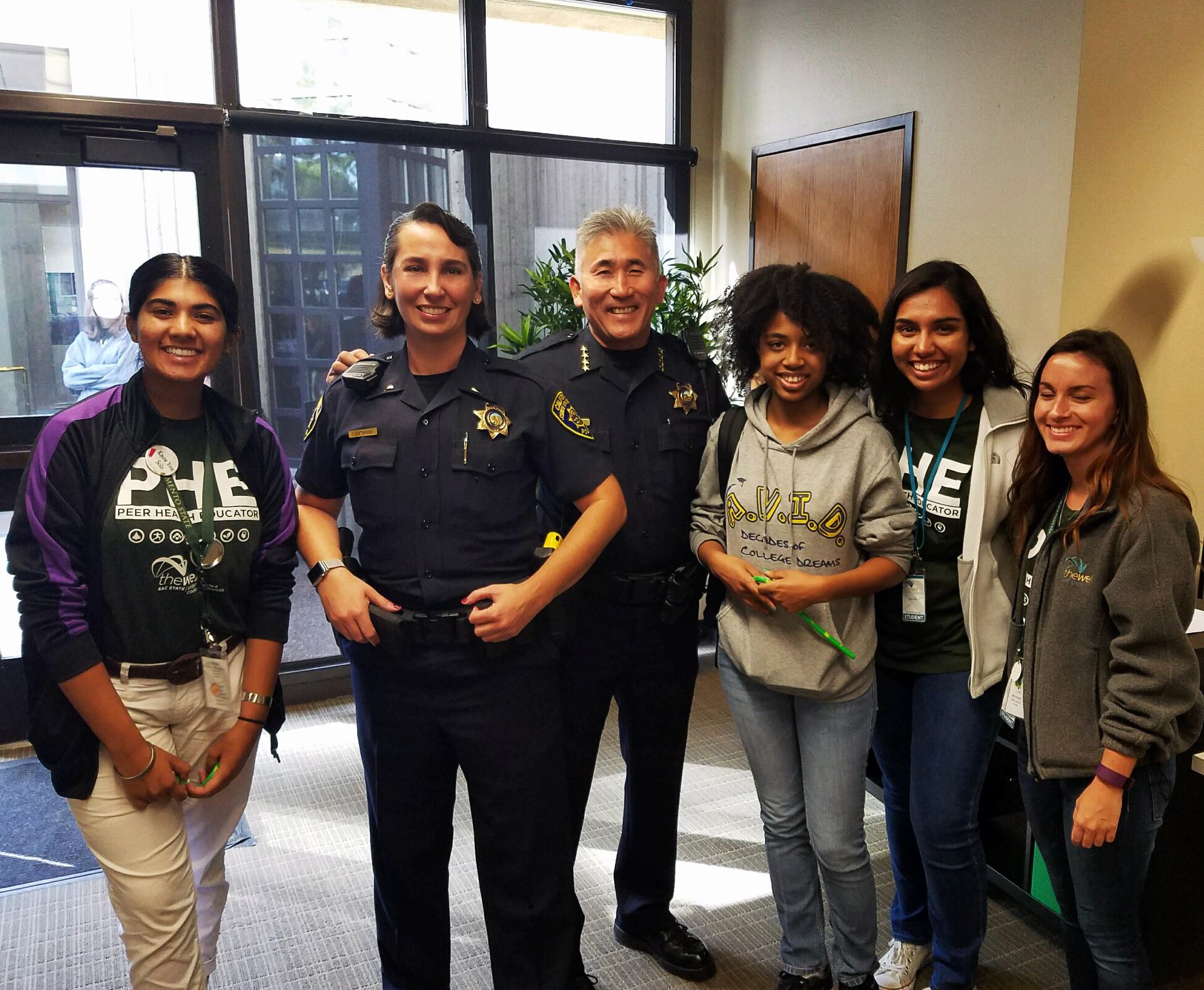 Community Service Officers pose with four female students