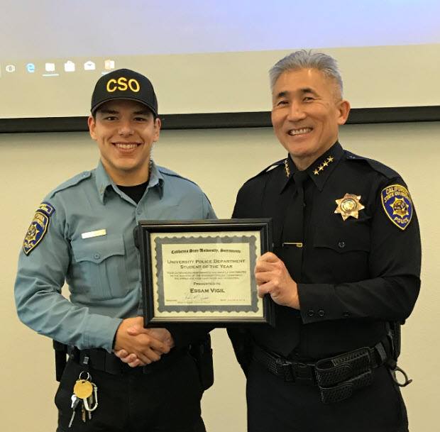 CSUS Police Chief Iwata presents a certificate to a male CSO