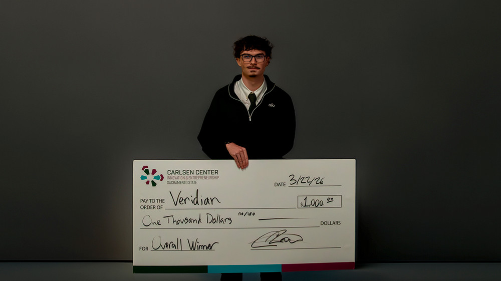 Anson Washeck holding $1,000 prize check