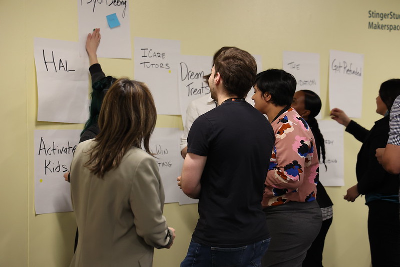 Attendees working through ideas using notes on the wall