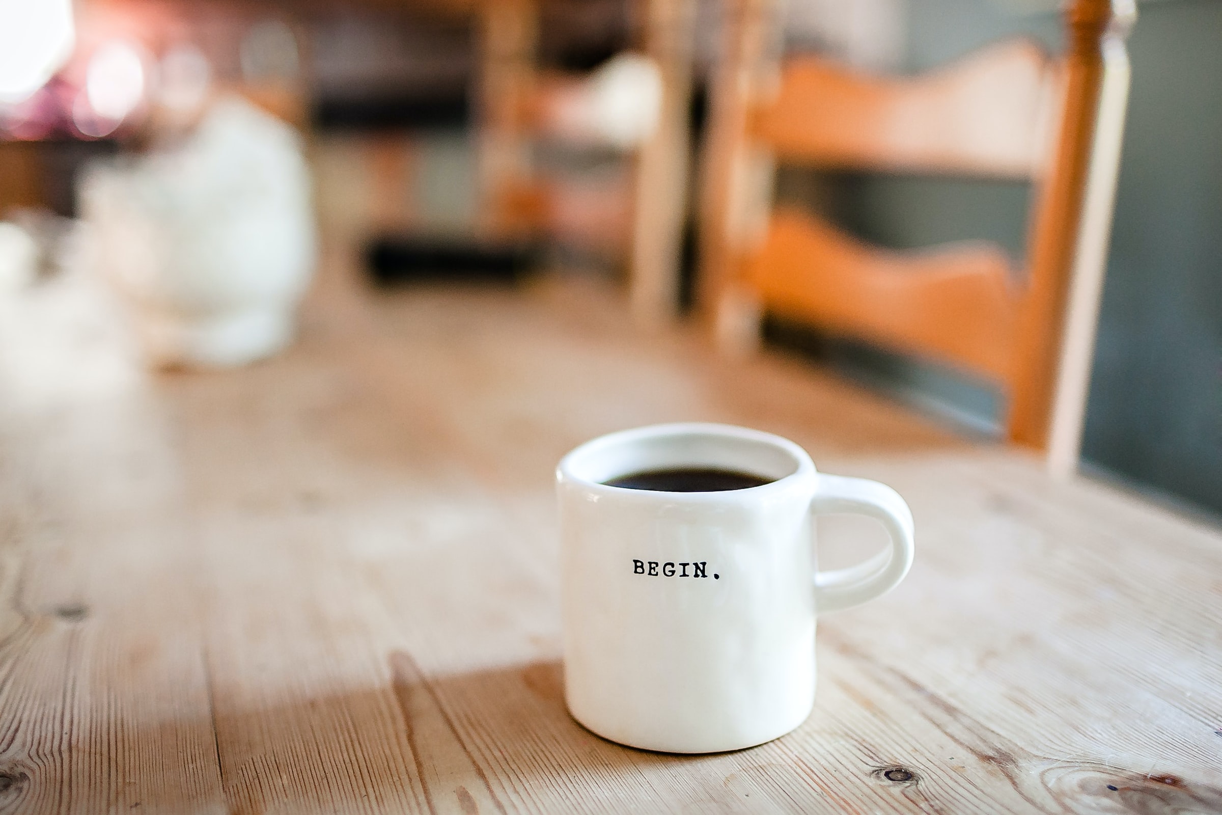 cThe word "Begin" on the side of a coffee cup