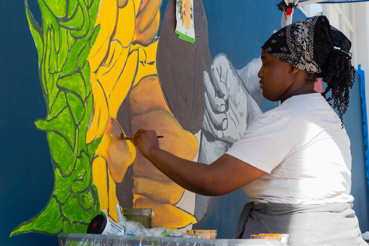 Art Student Amari Moore Painting Her Mural on Belonging Boulevard