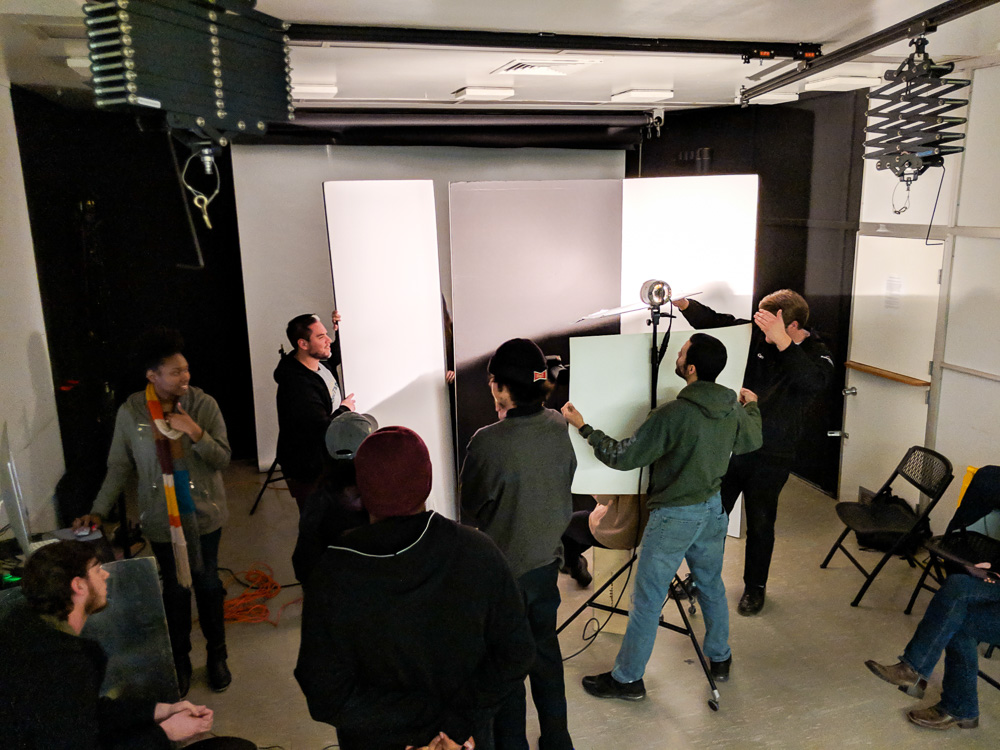 Sac State photo students work collaboratively in the lighting studio