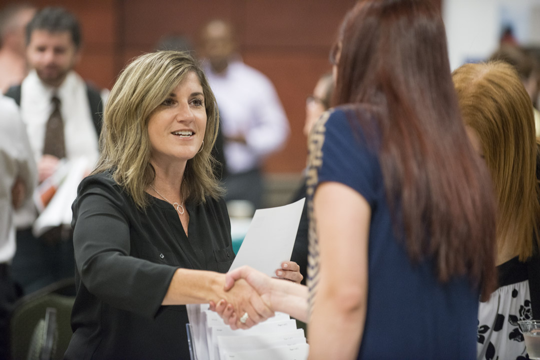 Woman introduces herself at a networking event.