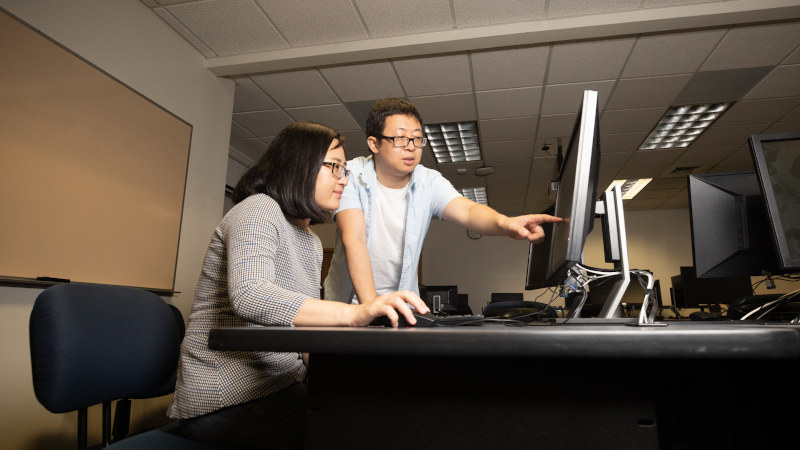 Computer Science professors Xiaoyan “Sherry” Sun, left, and Jun Dai secured a grant of more than $500,000 to develop a cybersecurity training program that will allow Sac State to offer certificates to high school teachers. (Sacramento State/Andrea Price)