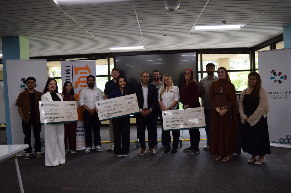 Participants and judges from the 2025 pitch competition standing together.