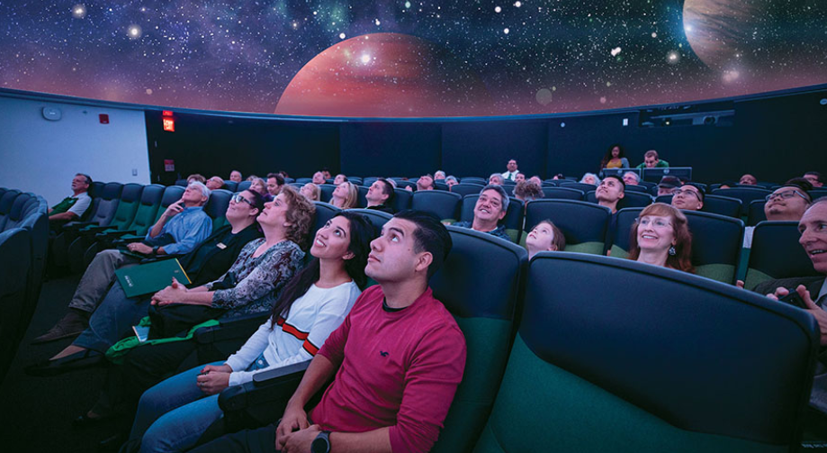 Image of people sitting inside the planetarium