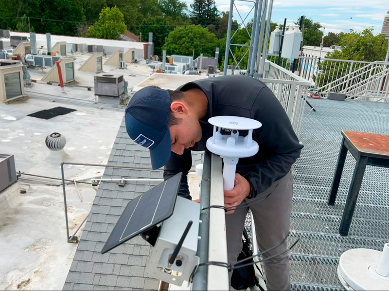 Adjusting rooftop air quality monitoring equipment, downtown Sacramento.