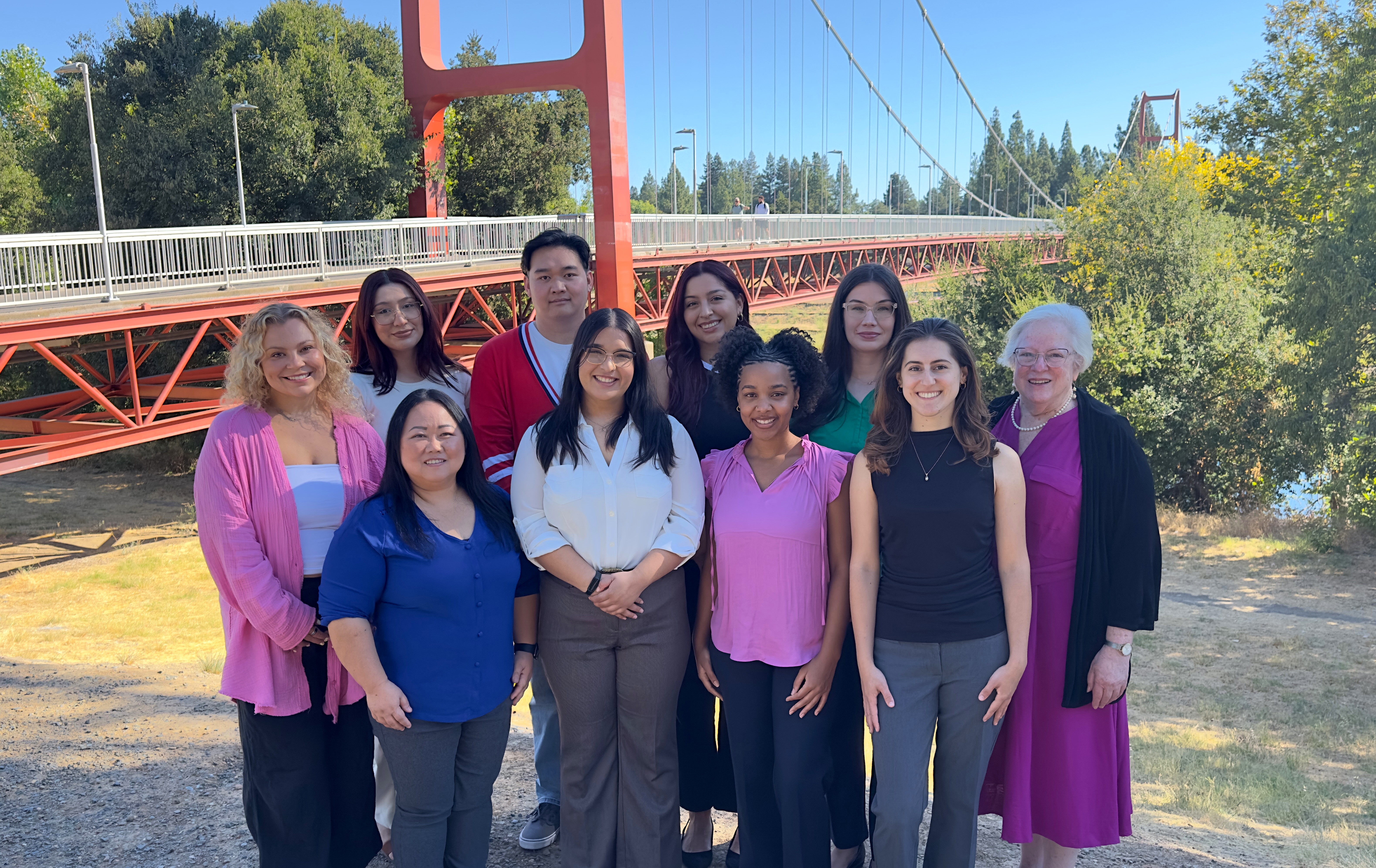 Dietetic internship cohort standing in front of Guy West Bridge. 