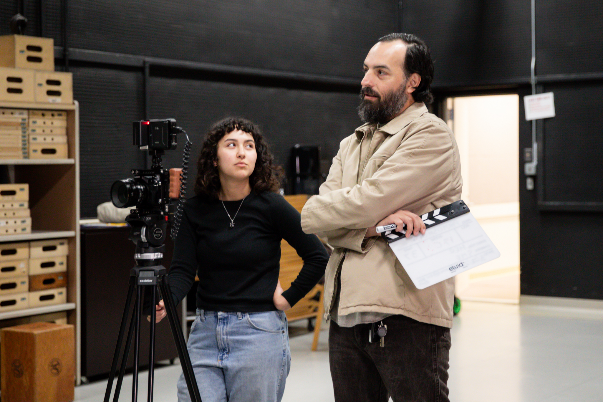 Rodrigo Ojeda-Beck, inside a studio, stands next to a Sac State student.