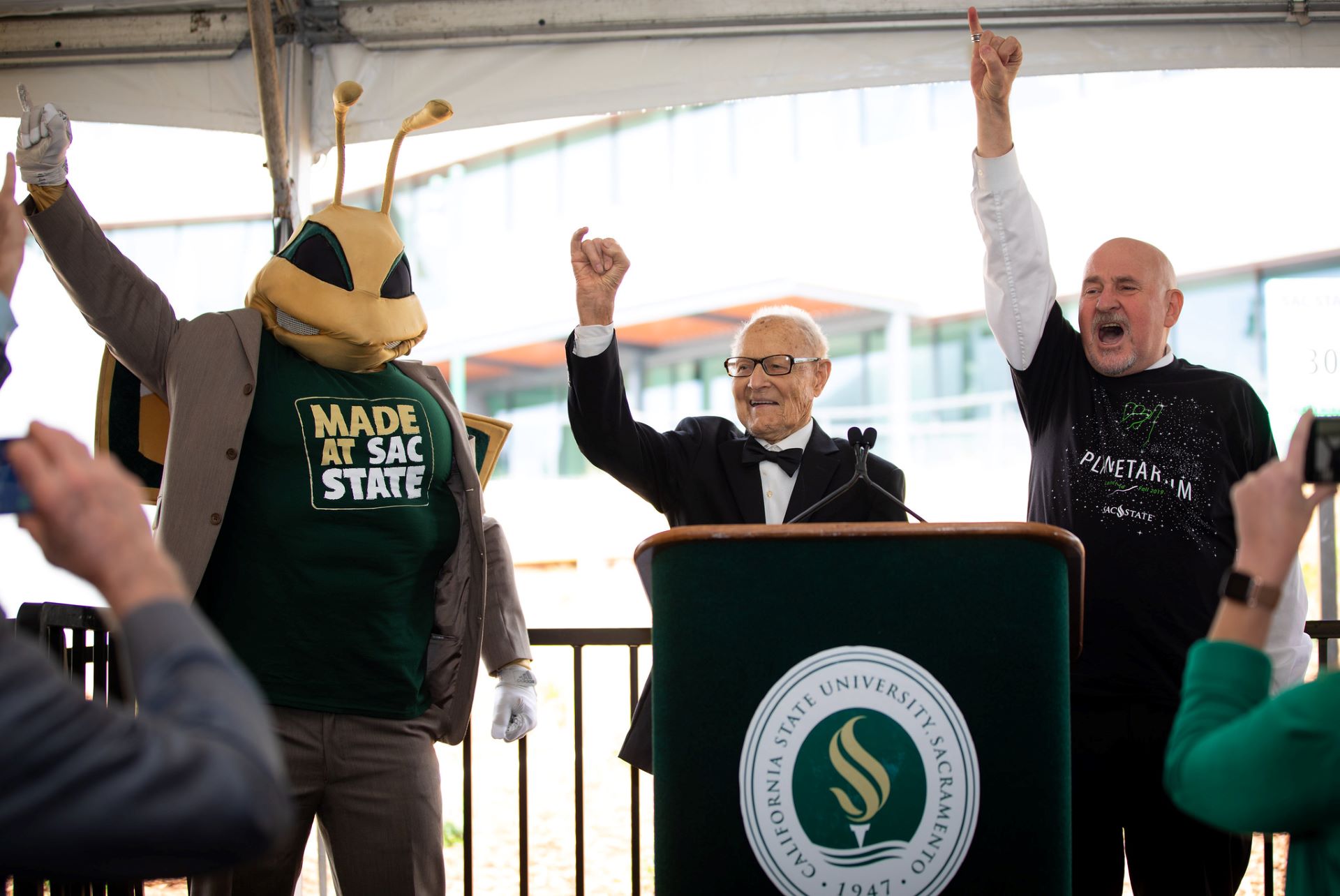 Herky, Ernest Tschannen, and President Robert Nelsen doing "Stingers Up!