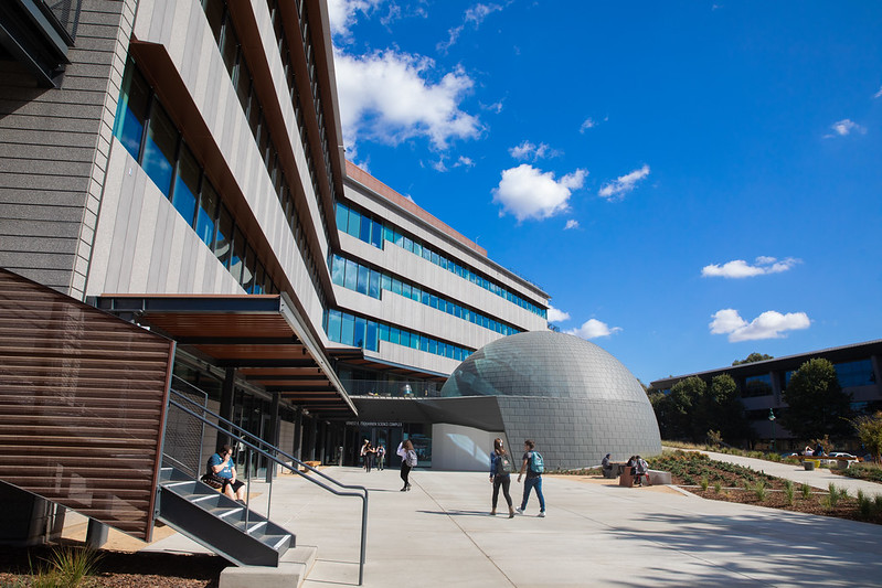 Exterior image of the science complex with students walking up to it