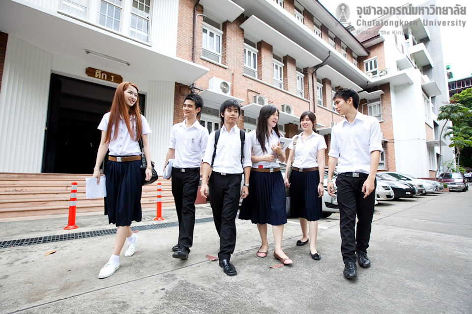 Group of Thai students walking in urban street.