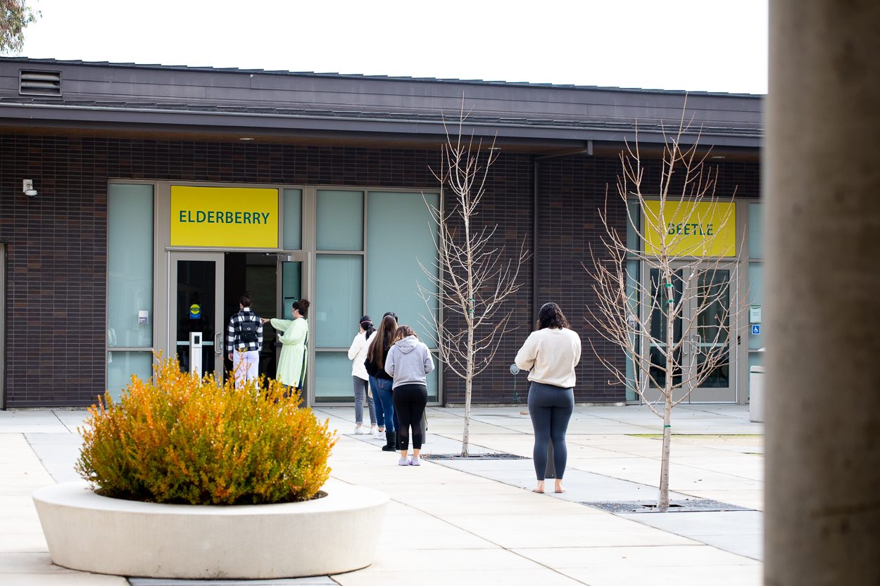 students wait in line outside 