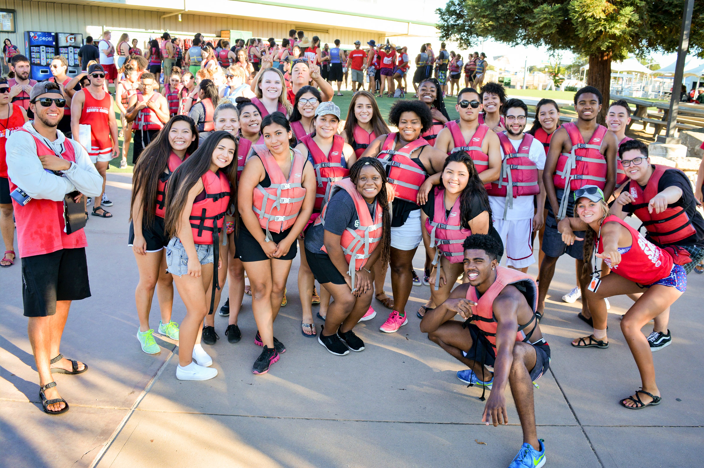 New students including Diana Contreras and DeAndre Wiltz post on the dock at the Sac State Aquatic Center in 2016
