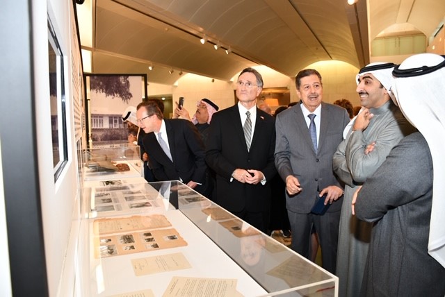 Doug Lipp and others standing in front of a museum glass case