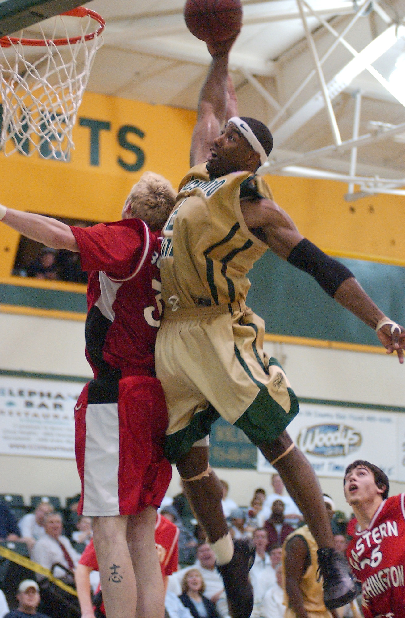 Jameel Pugh in a Sac State basketball uniform dunking