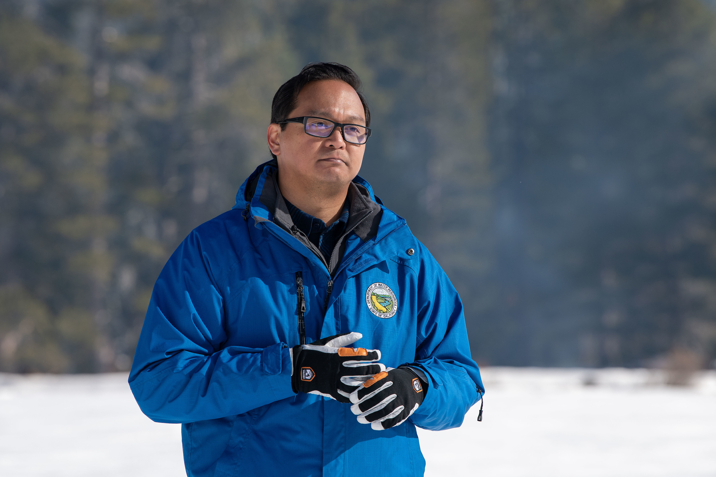 Sean de Guzman, in a blue winter jacket, standing outdoors in the Sierra Nevada