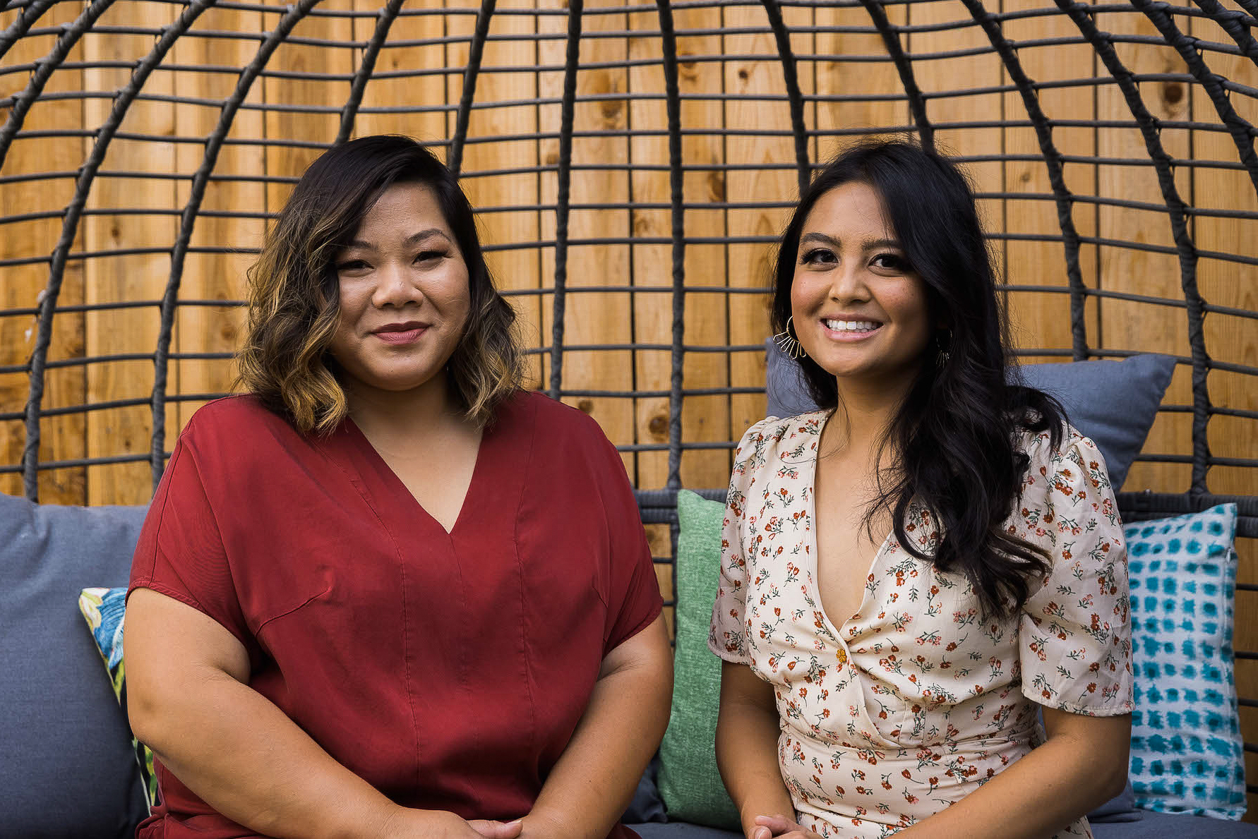 Christy Innouvong-Thornton and Beatriz Aurelio-Saguin sitting on a bench