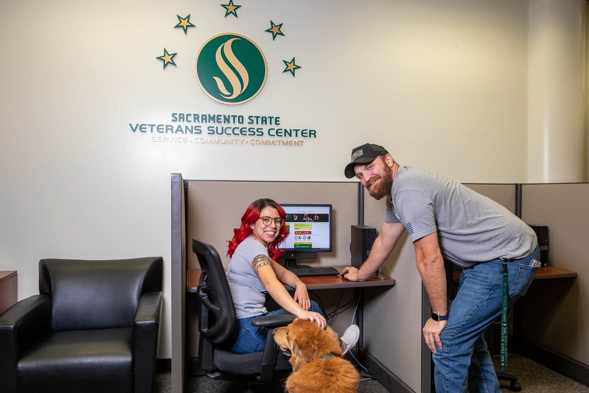 Jennifer Gomez and Elias Kruse, in the Veterans Success Center, posing for a photo near a computer