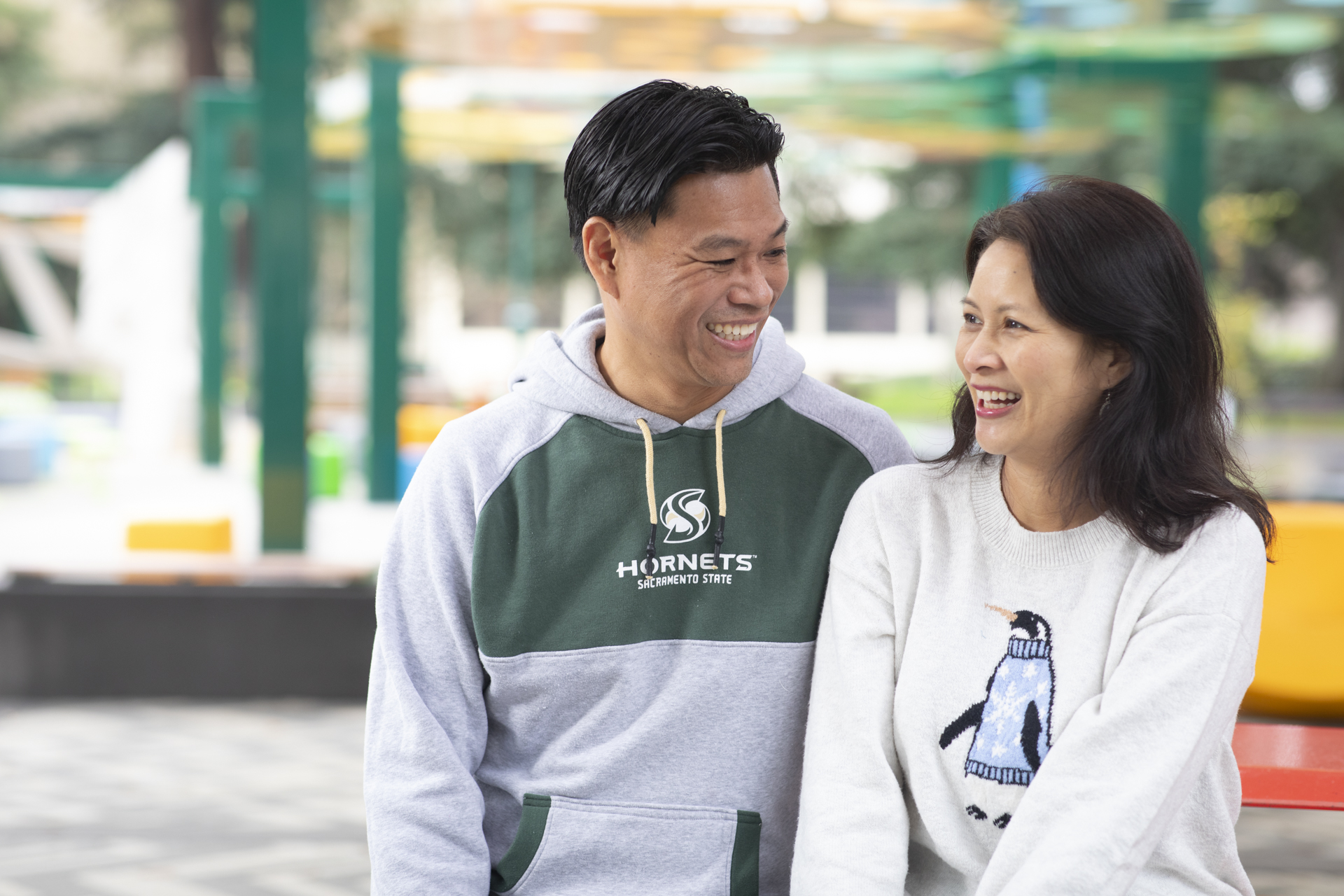 Baldwin Chiu and his wife Larissa Lam smile at each other on campus.