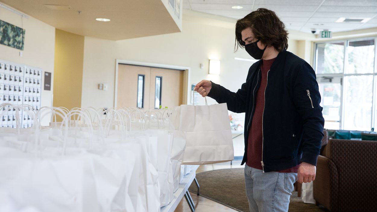 Resident assistant Joey Curley organizes meals provided for residence hall students through a program out of Sacramento Mayor Darrell Steinberg's office and prepared by notable Sacramento restaurants. (Sacramento State/Andrea Price)