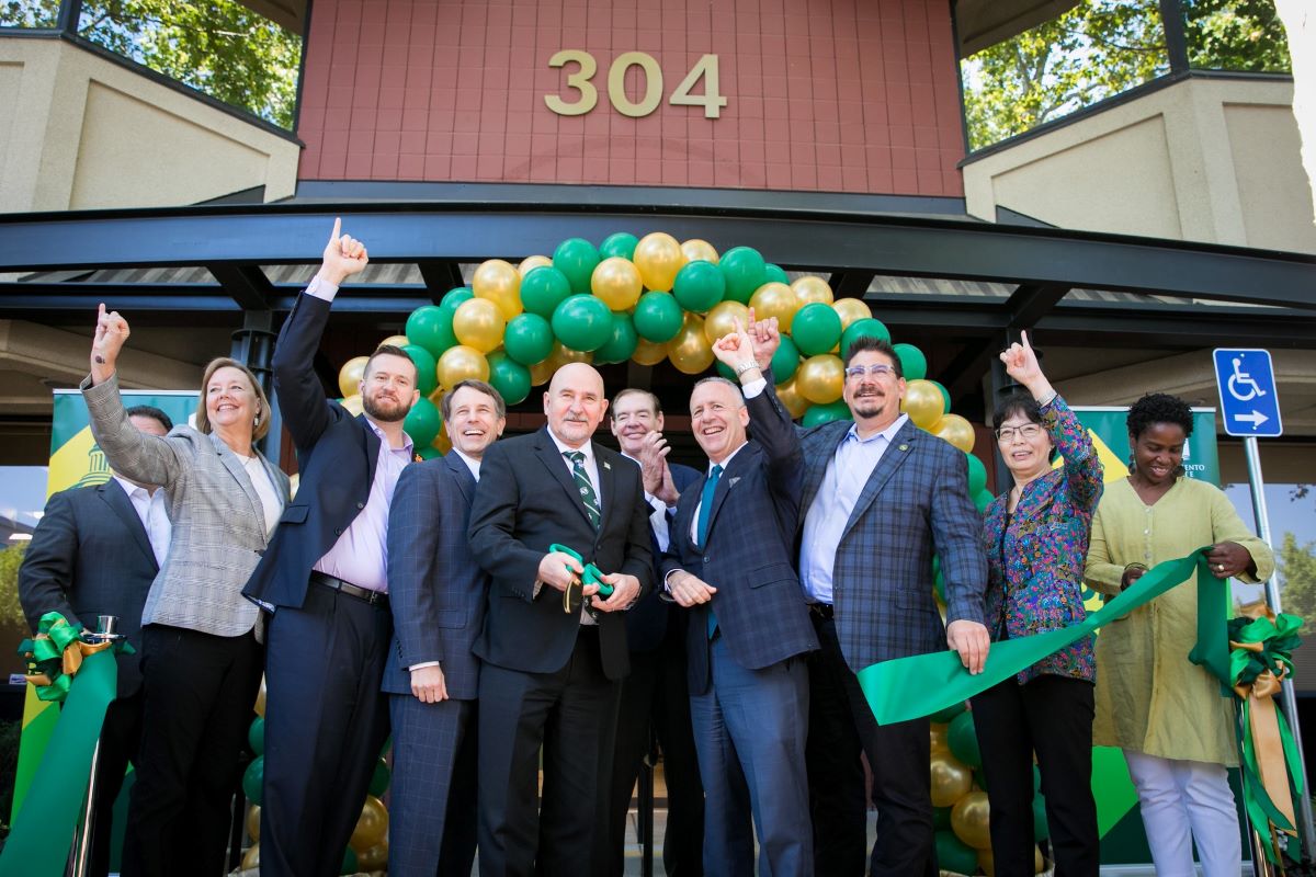 Sac State President Robert S. Nelsen, center, with scissors, is joined by other community and University dignitaries during the official opening of Sac State Downtown in August 2018. (Sacramento State/Jessica Vernone)