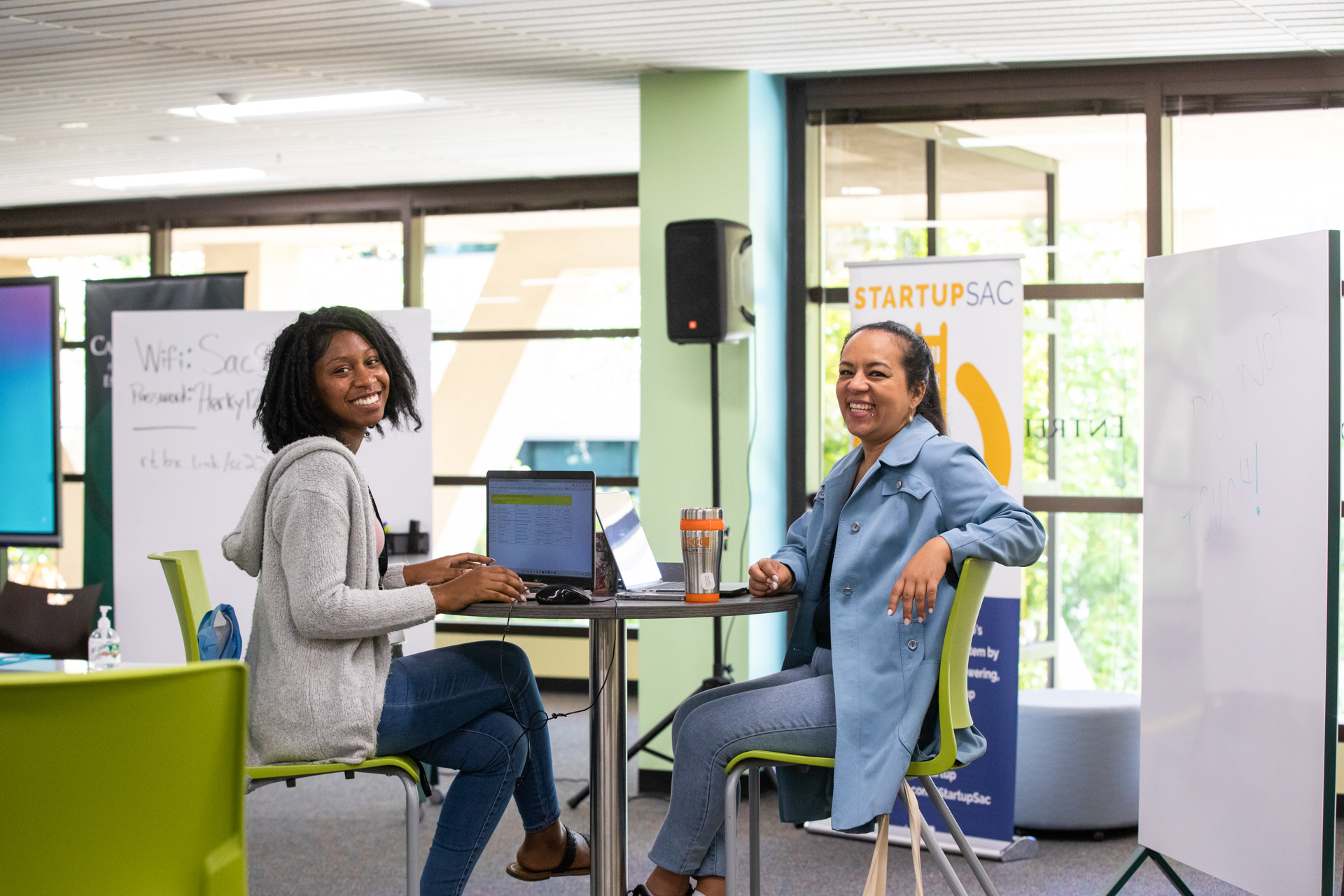 Visitors to the Carlsen Center, like the two women shown sitting at a table here, can learn about business, products, entrepreneurship and more.