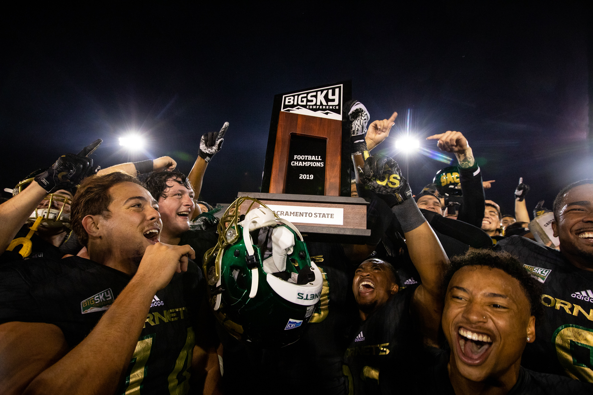 The Sacramento State Hornets football team celebrating with the Big Sky Championship trophy.