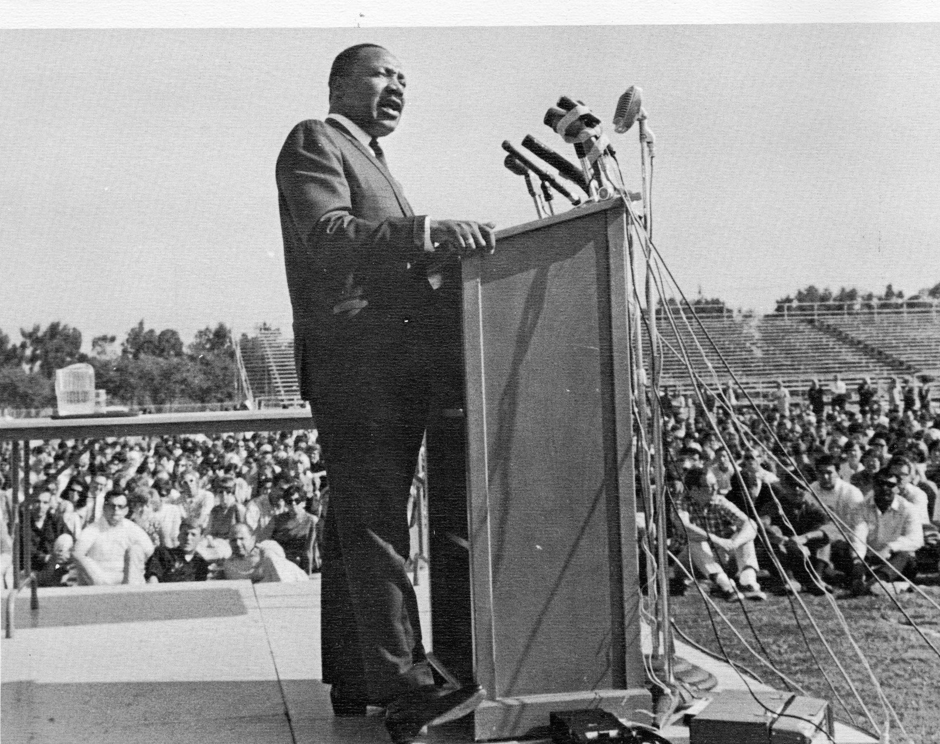 A historic photo of Martin Luther King Jr. speaking at a podium at Sac State. 