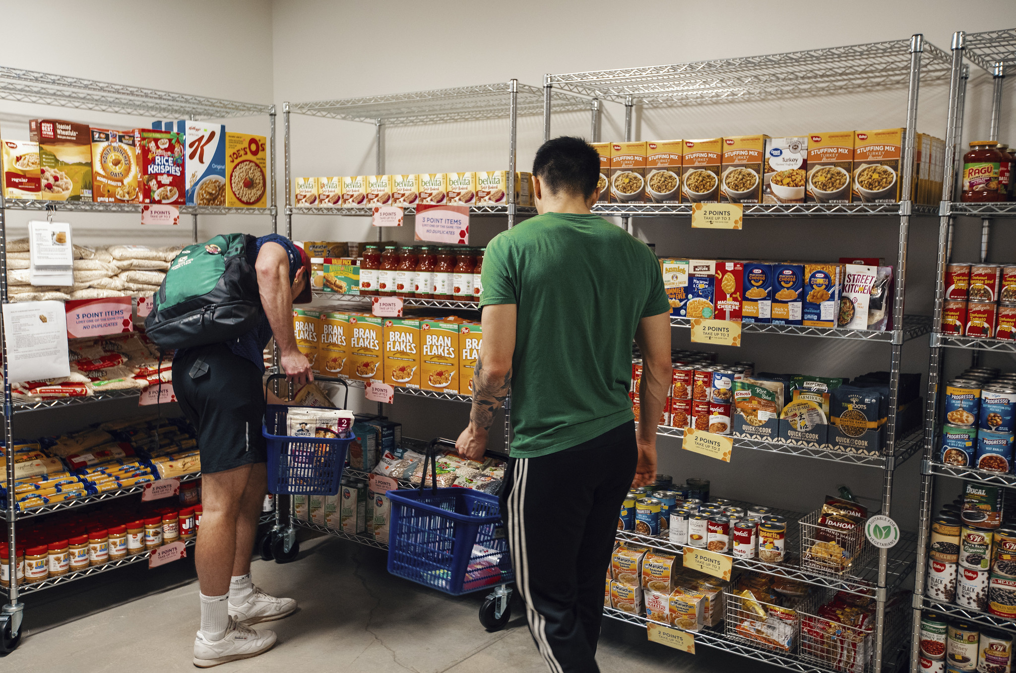 ASI Food Pantry visitors fill their baskets with produce, canned goods, and more.