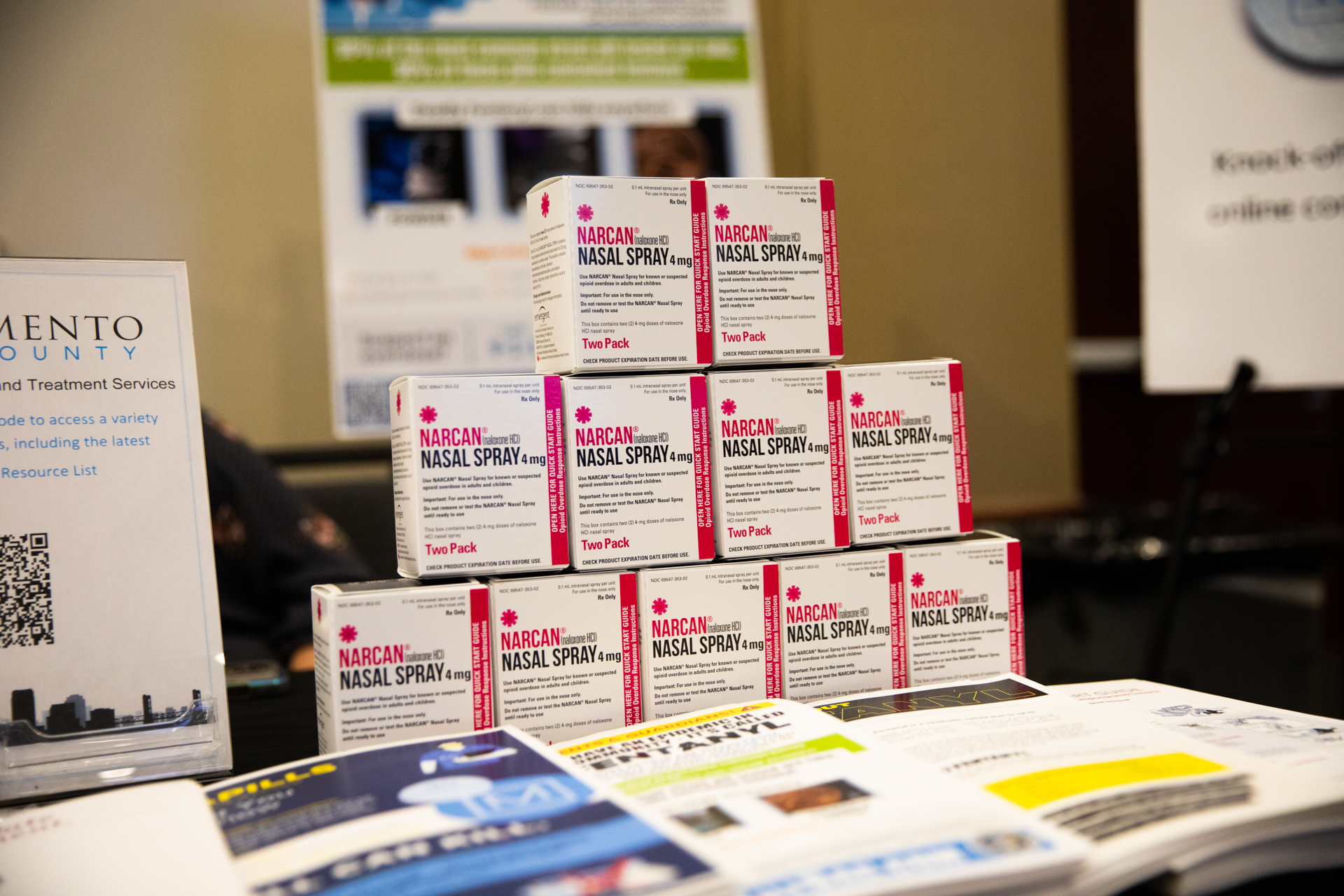 Boxes of Narcan, a nasal spray that can reverse opioid overdoses, sit atop an information table at the Opioid Awareness Summit at Sac State.