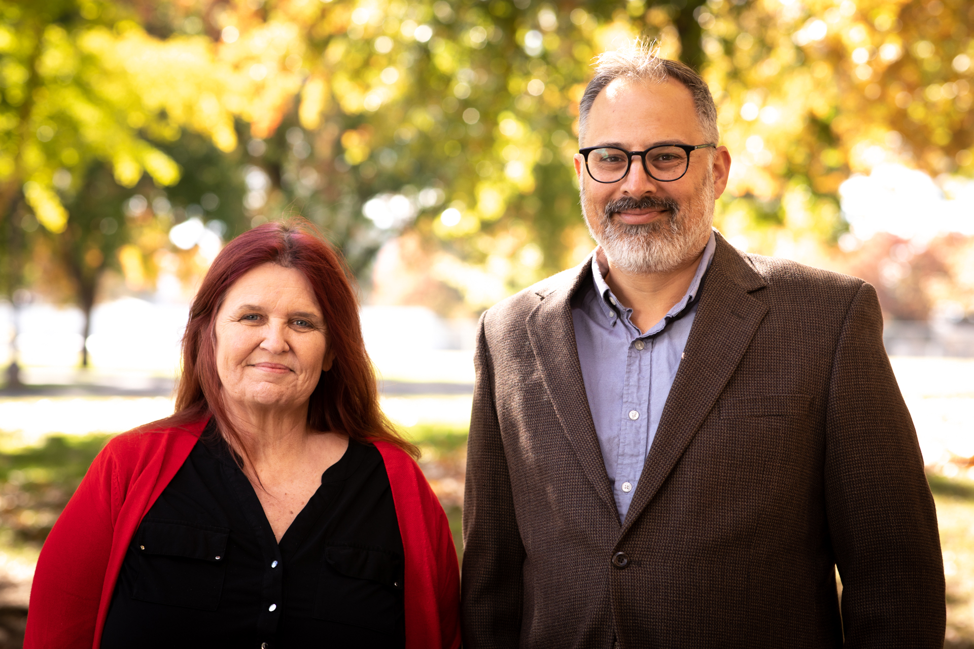 Roslyn Roberts and Ajay Singh pose on the backdrop of trees on the Sac State campus. 