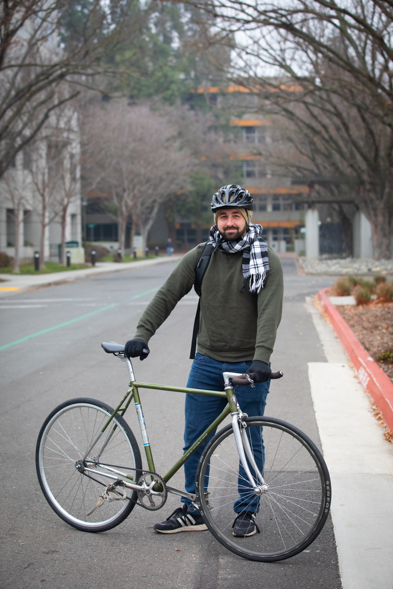 Sacramento State employee Joshua Maddox poses with his bicycle on campus.