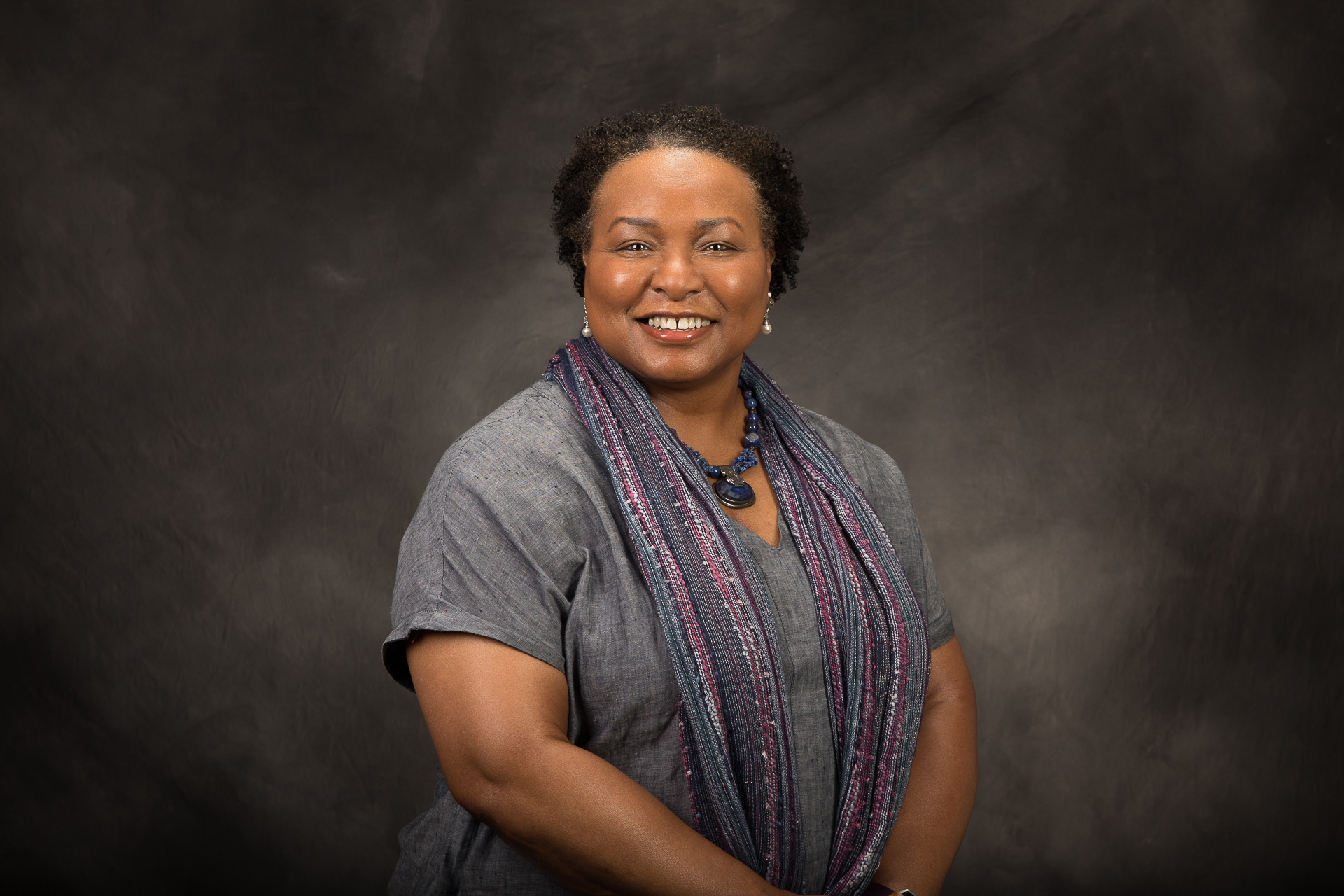 Sac State Associate Vice President for Research, Innovation, and Economic Development Yvonne Harris posing on a black and grey studio background.