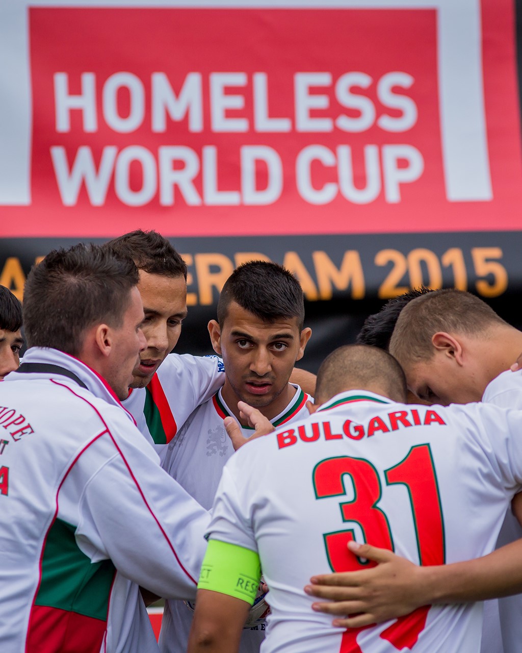 Homeless World Cup players embrace during a game. 