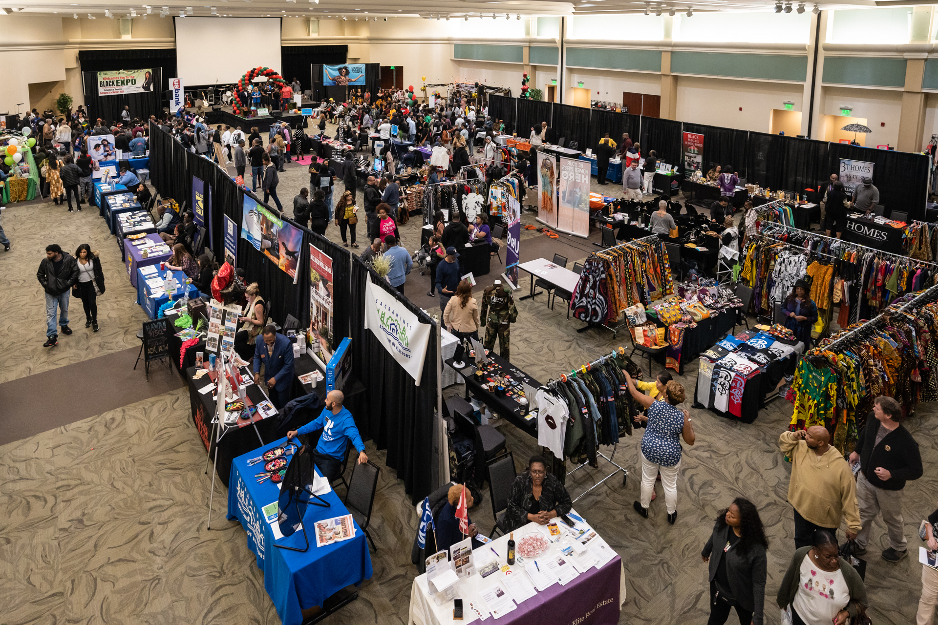 Tables, presenters and attendees in the University Union ballroom during the Sacramento Black Expo