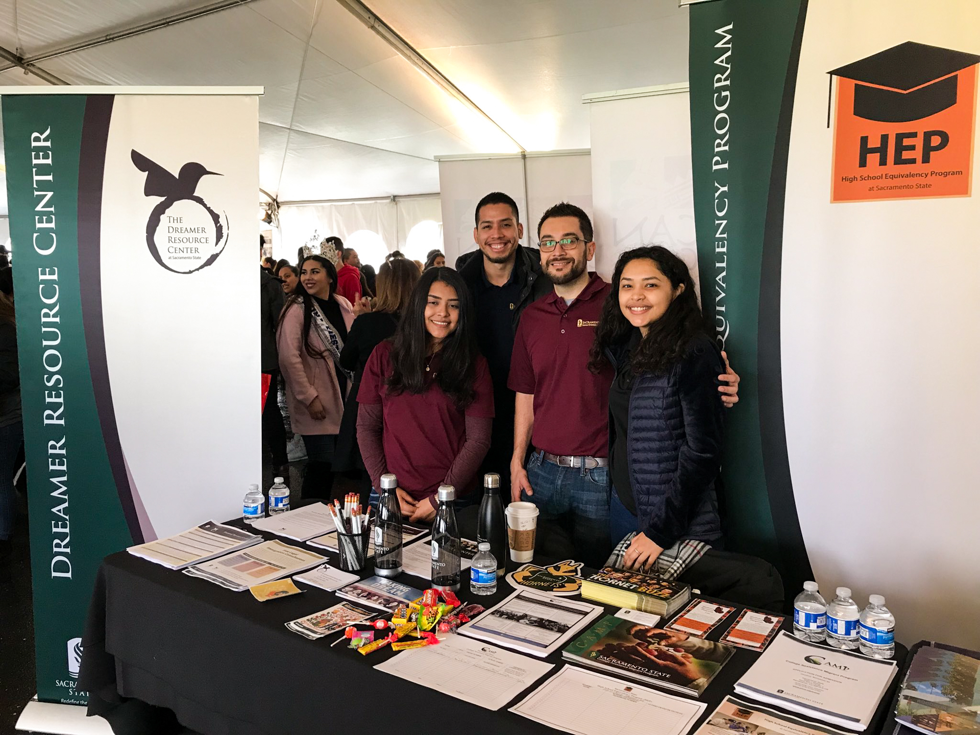 Students stand behind an information table while attending a Dreamer Resource Center event at Sacramento State.