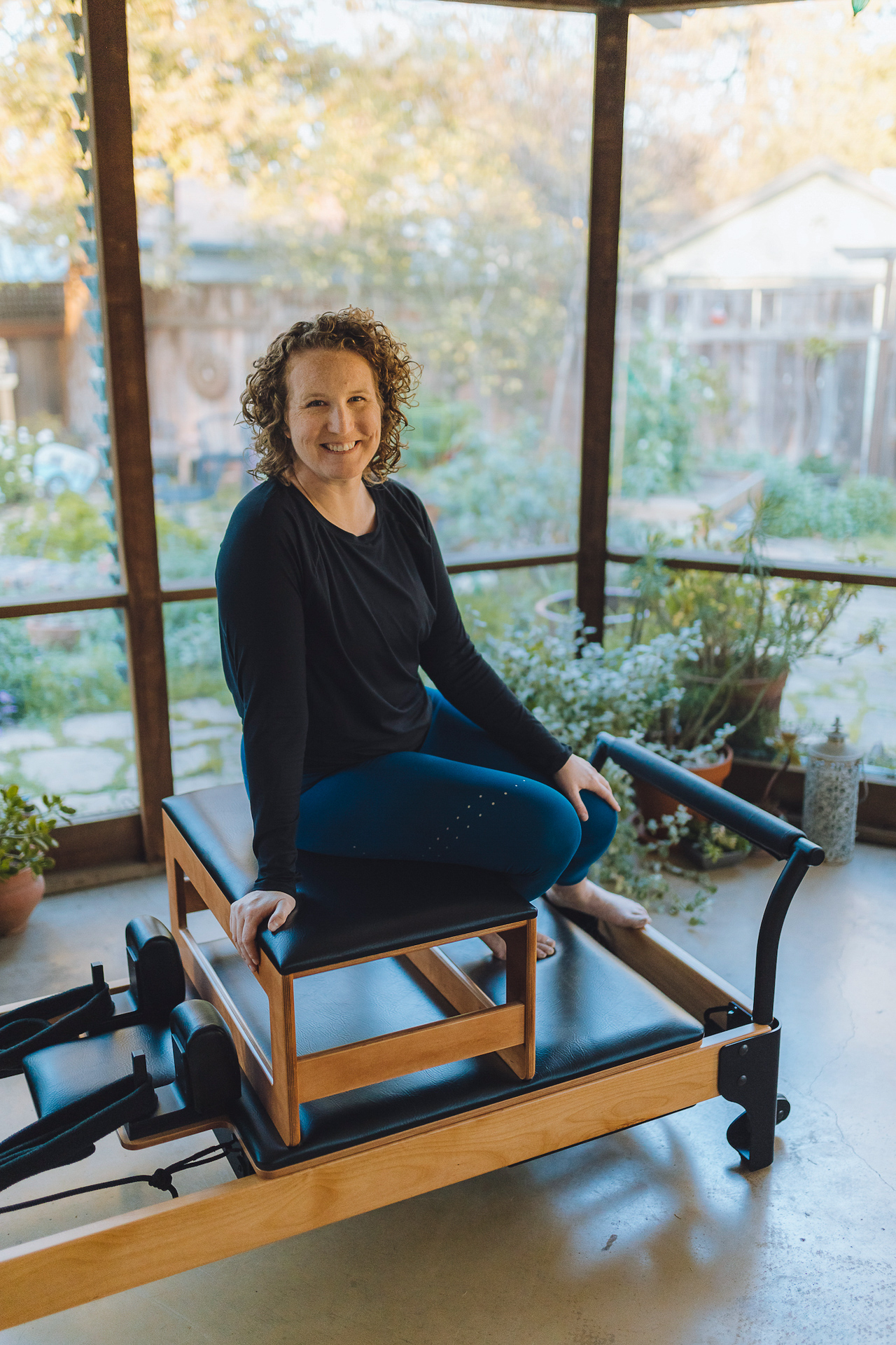 Kaleen Canevari, a mechanical engineer-turned-Pilates instructor, sits on the Flexia exercise machine she invented.