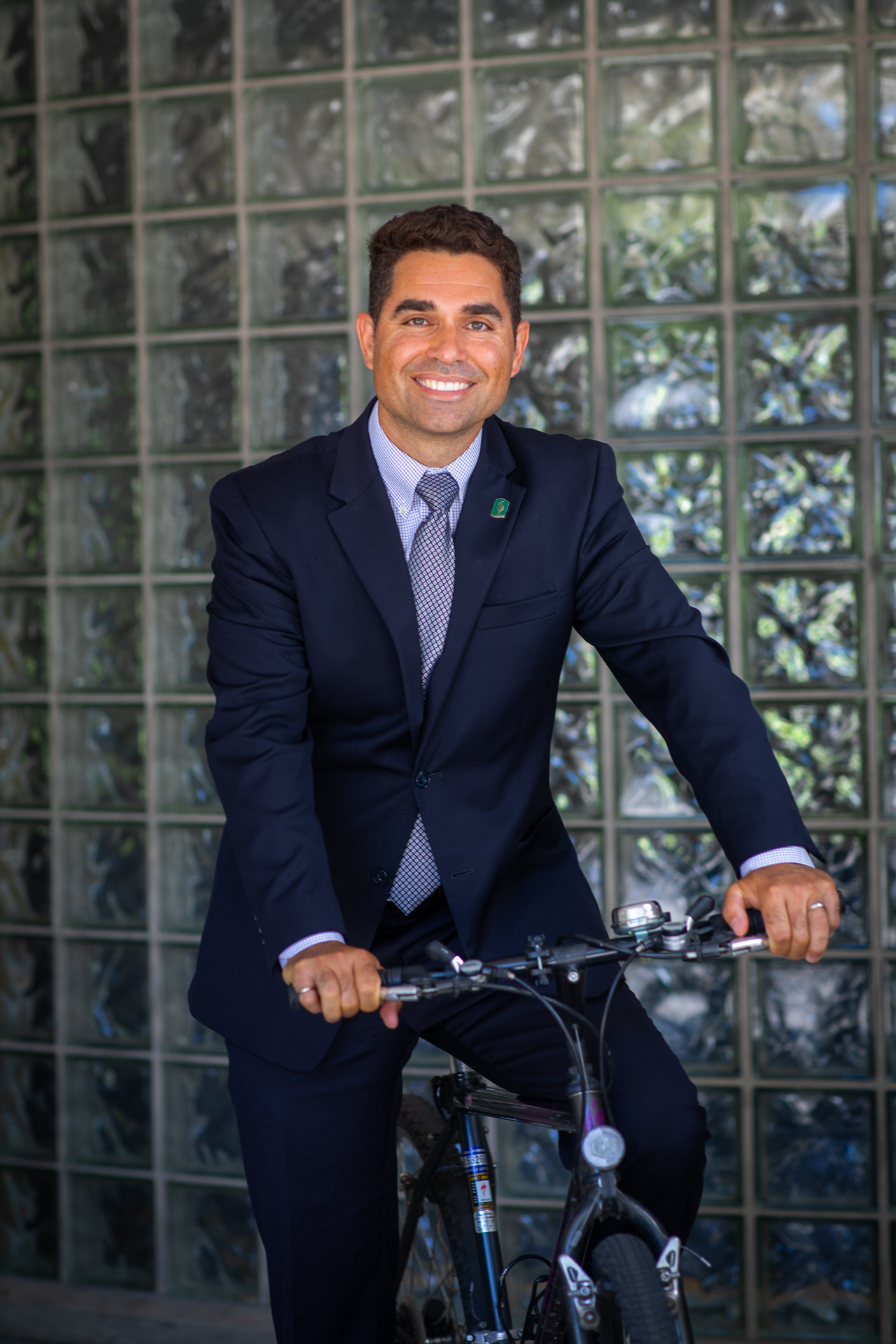 Kevan Shafizadeh, new dean of the College of Engineering and Computer Science (ECS), sits on his bike in front of Riverside Hall at Sacramento State.