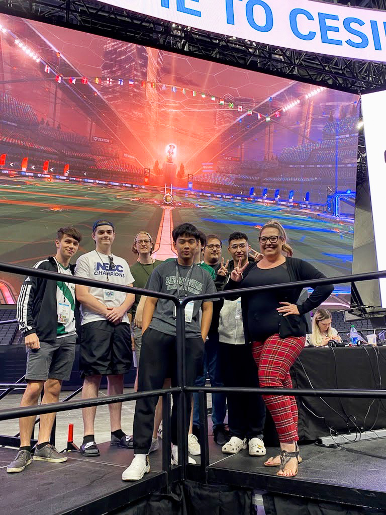 Sac State esports team members pose in a group on stage during a recent College Esports International (CESI) tournament at the Golden 1 Center in Sacramento.