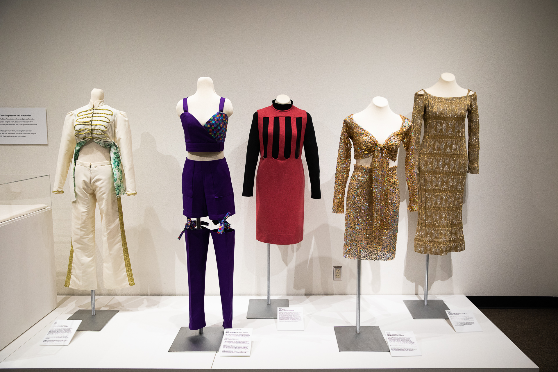 Five of the clothing outfits from eras between the 1860s and 1980s, on display as part of Sacramento State's "Dressing Sacramento: 120 Years of Fashion" exhibit in the University Library Gallery.